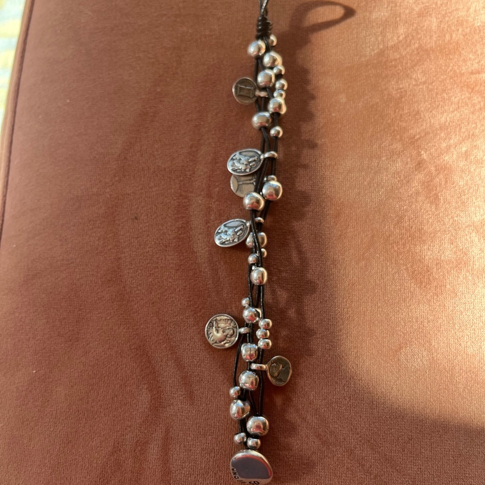 Uno de 50 leather and silver metal bracelet.